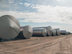 Novid stainless steel liquid storage tanks laying down in the yard