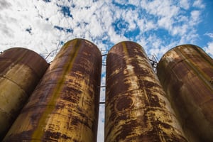 rusty mild steel tanks with blue sky